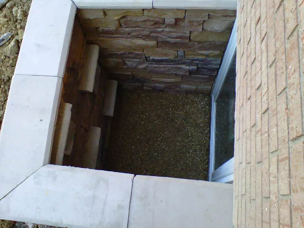 Custom Stone Egress Window Well with Stone Ladder