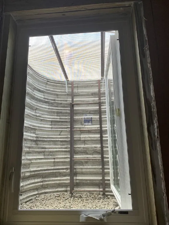 Thermal hinged cover over StoneView steel egress window well